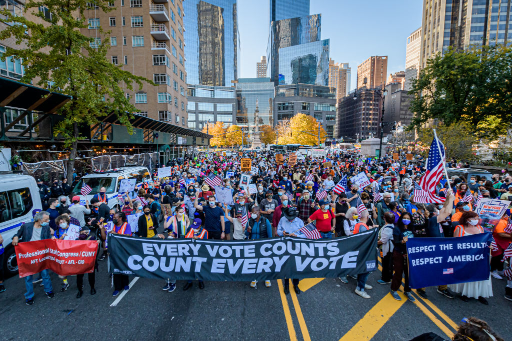 Participants at the front of the march holding a banner...