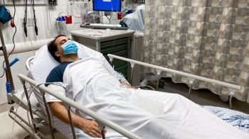 Latin man recovering in a hospital bed