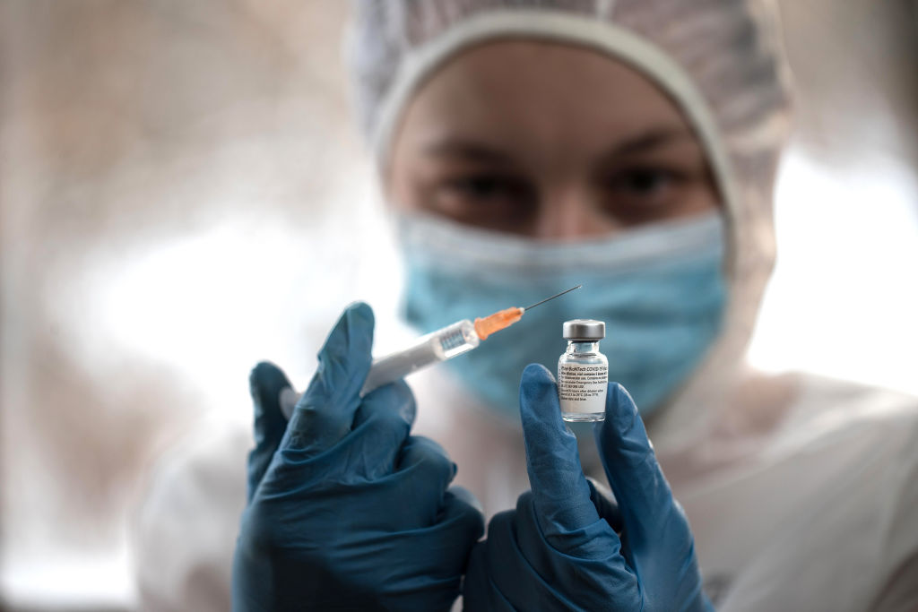 In this photo illustration a medical worker holding a...