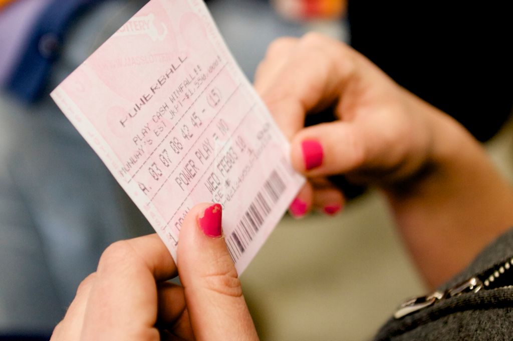 (013110 Boston, Mass.) PWRBALL Kerry Byrne, 22, an employee at The Hub liquor store in South Boston, looks at her Powerball numbers after purchasing a ticket on Jan. 31, 2010. Sunday was the first day Powerball tickets were being sold in Massachus