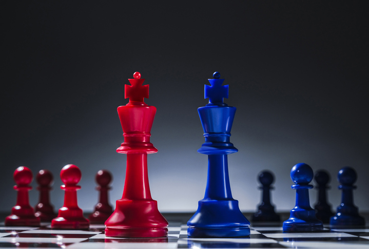 Studio shot of red and blue chess pawns symbolizing US Democratic and Republican parties