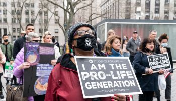 A woman holding a placard takes part during anti-abortion...