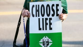 A demonstrator holds a placard reading "choose life" during...