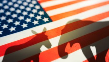 animal shadows on the flag. Democrats vs republicans are in ideological duel on the american flag. In American politics US parties are represented by either the democrat donkey or republican elephant