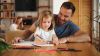 Father and daughter having a good time while drawing at home