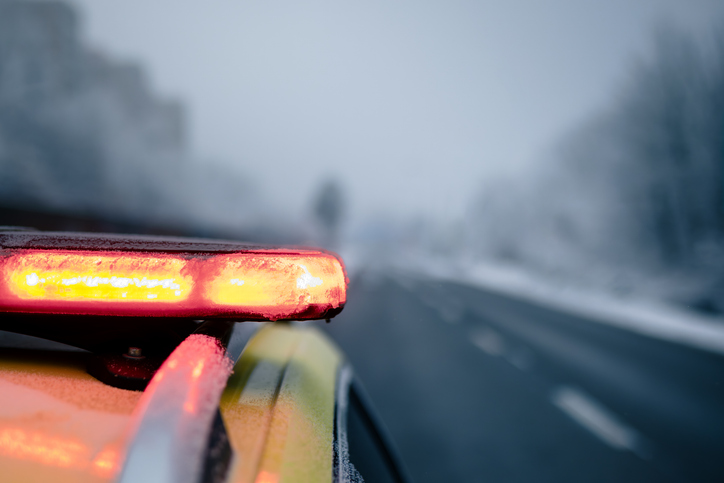 Red flashing light on ambulance car on frosty winter day