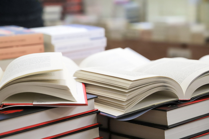 stack of books on the table. open book