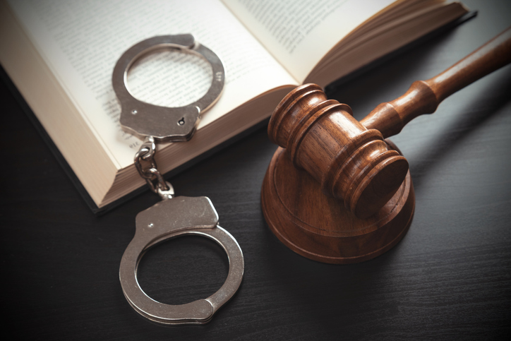 Handcuffs and wooden gavel. Law concept