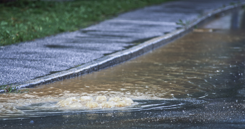 Flooded water flowing on road