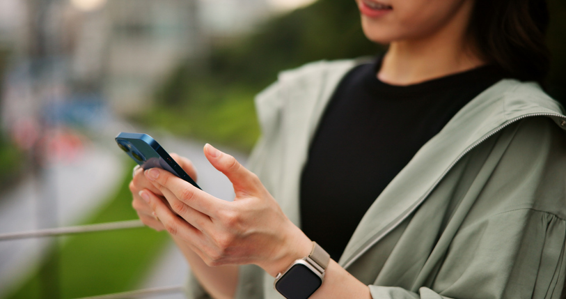 Phone, hand and woman outdoor with online exercise plan for running, wellness and training. Closeup, fitness and female athlete on cellphone with mobile health tracker app for cardio workout