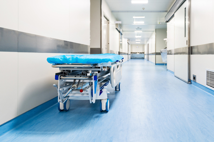 Empty bed in hospital corridor
